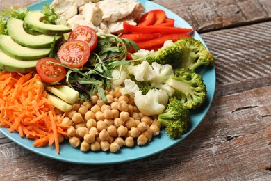 Photo of Balanced diet and healthy foods. Plate with different delicious products on wooden table