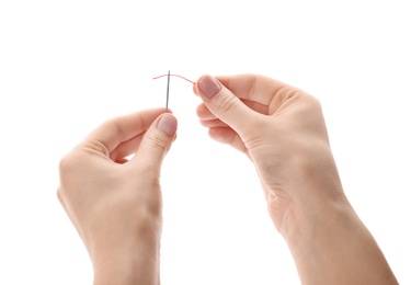 Photo of Woman threading needle on white background