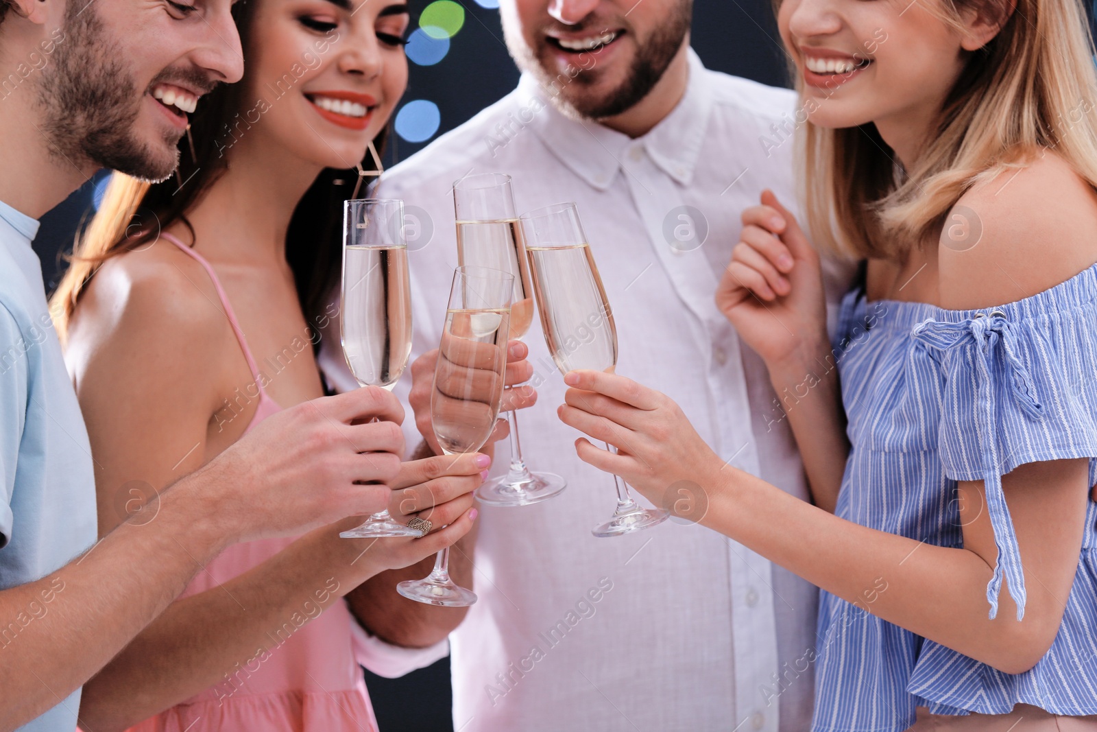 Photo of Friends clinking glasses with champagne, closeup. Party time