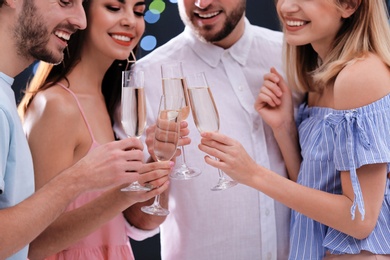 Photo of Friends clinking glasses with champagne, closeup. Party time