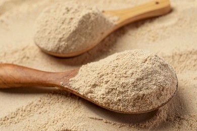 Photo of Buckwheat flour and wooden spoons, closeup view