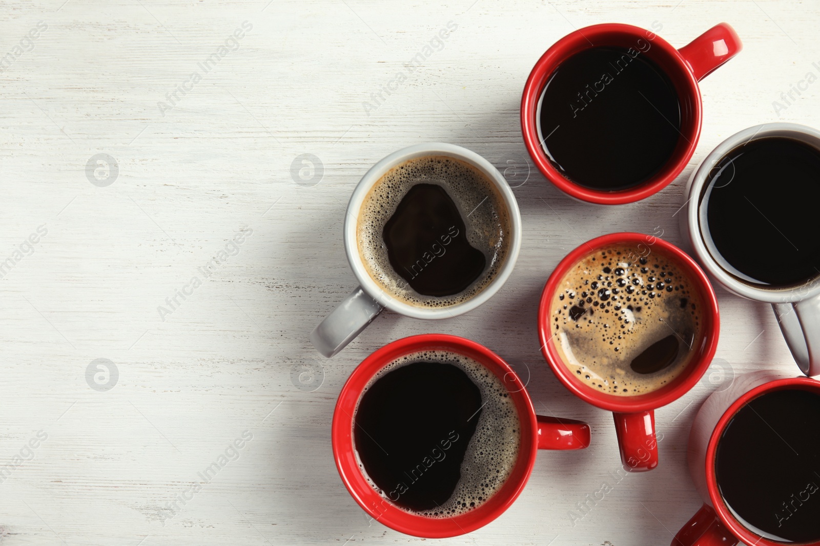 Photo of Flat lay composition with cups of coffee on light background. Food photography