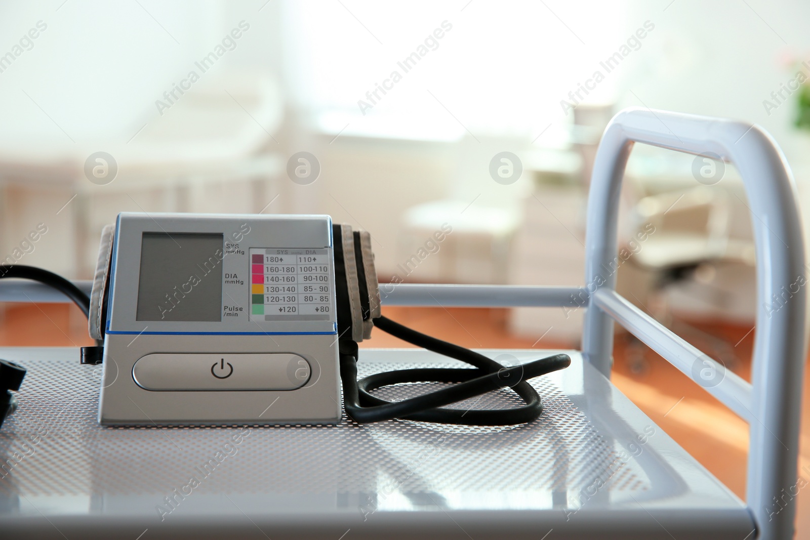 Photo of Modern blood pressure monitor on cart in medical office