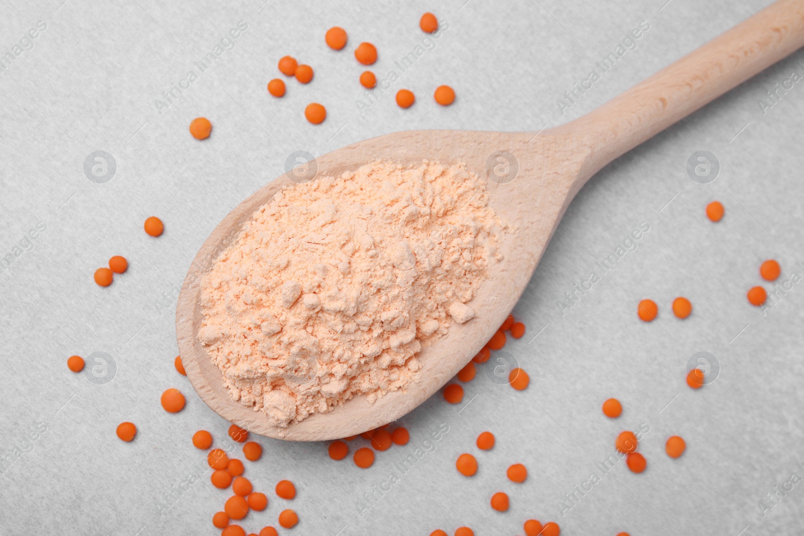 Photo of Spoon of lentil flour and seeds on white table, flat lay