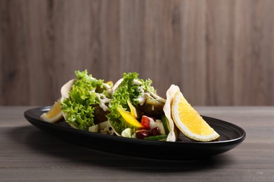 Photo of Delicious fresh vegan tacos served on wooden table