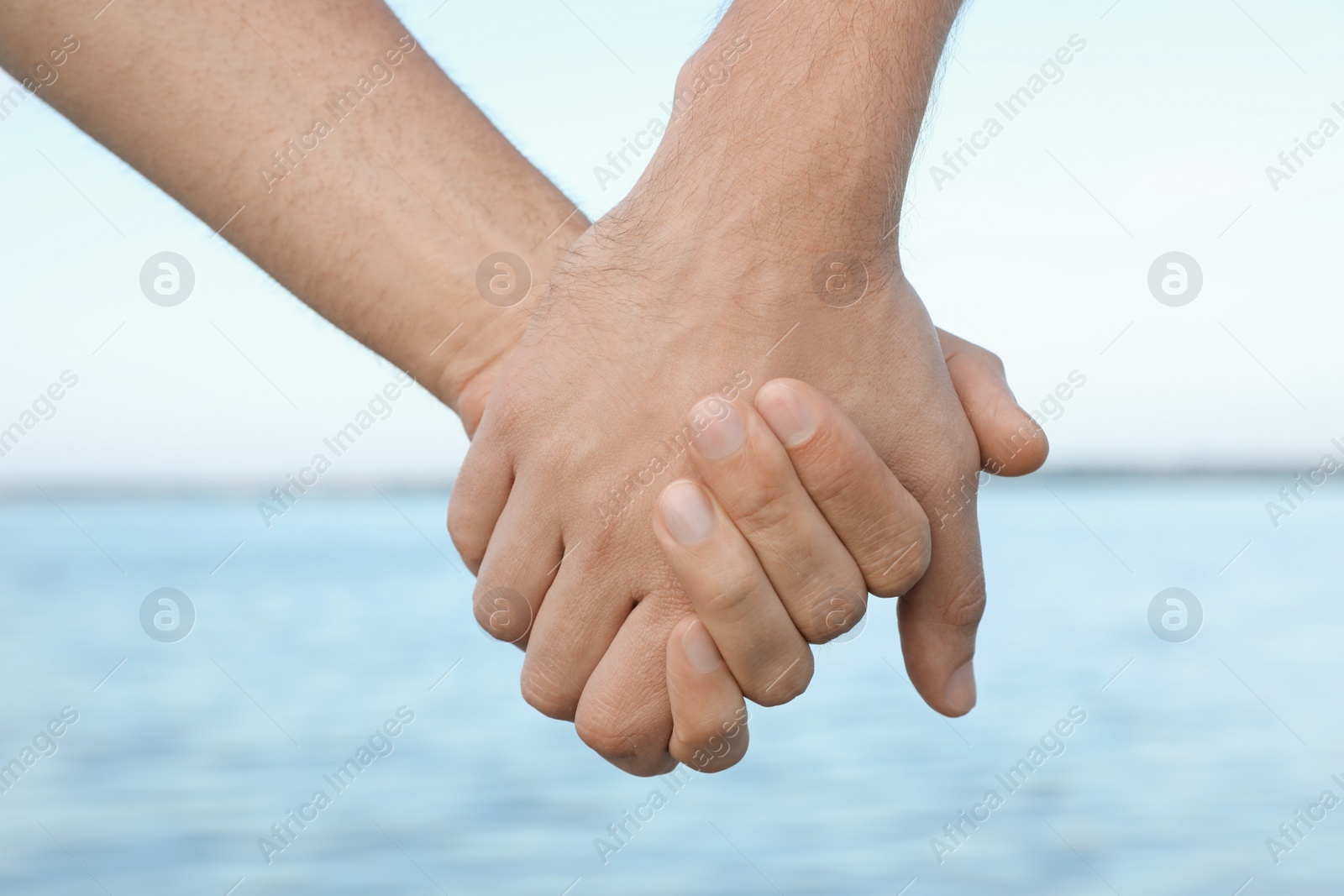 Photo of Gay couple near river on sunny day, closeup