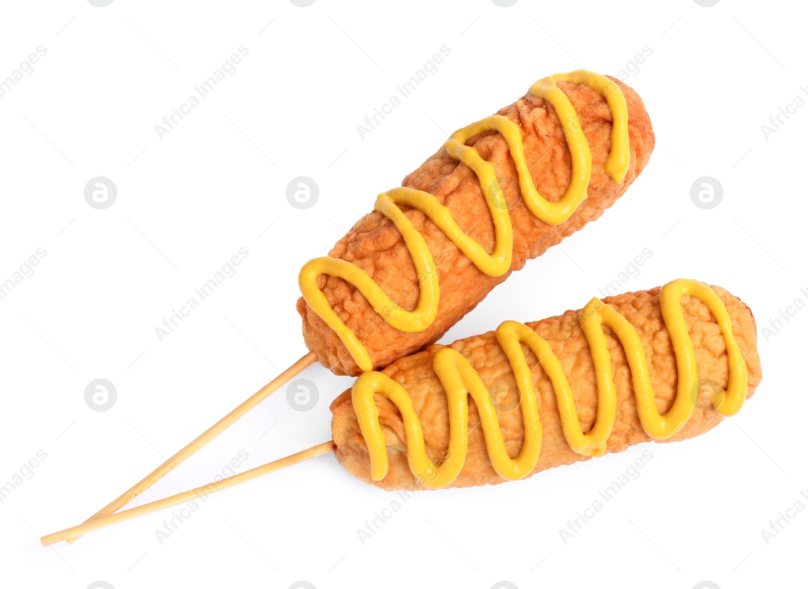 Photo of Delicious deep fried corn dogs with mustard on white background, top view