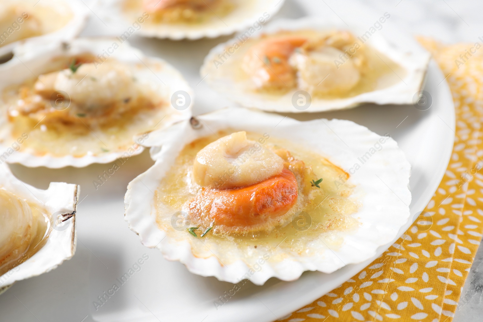 Photo of Fried scallops in shells on table, closeup