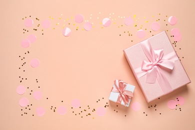 Photo of Frame of shiny confetti and beautiful gift boxes on color background, flat lay. Space for text