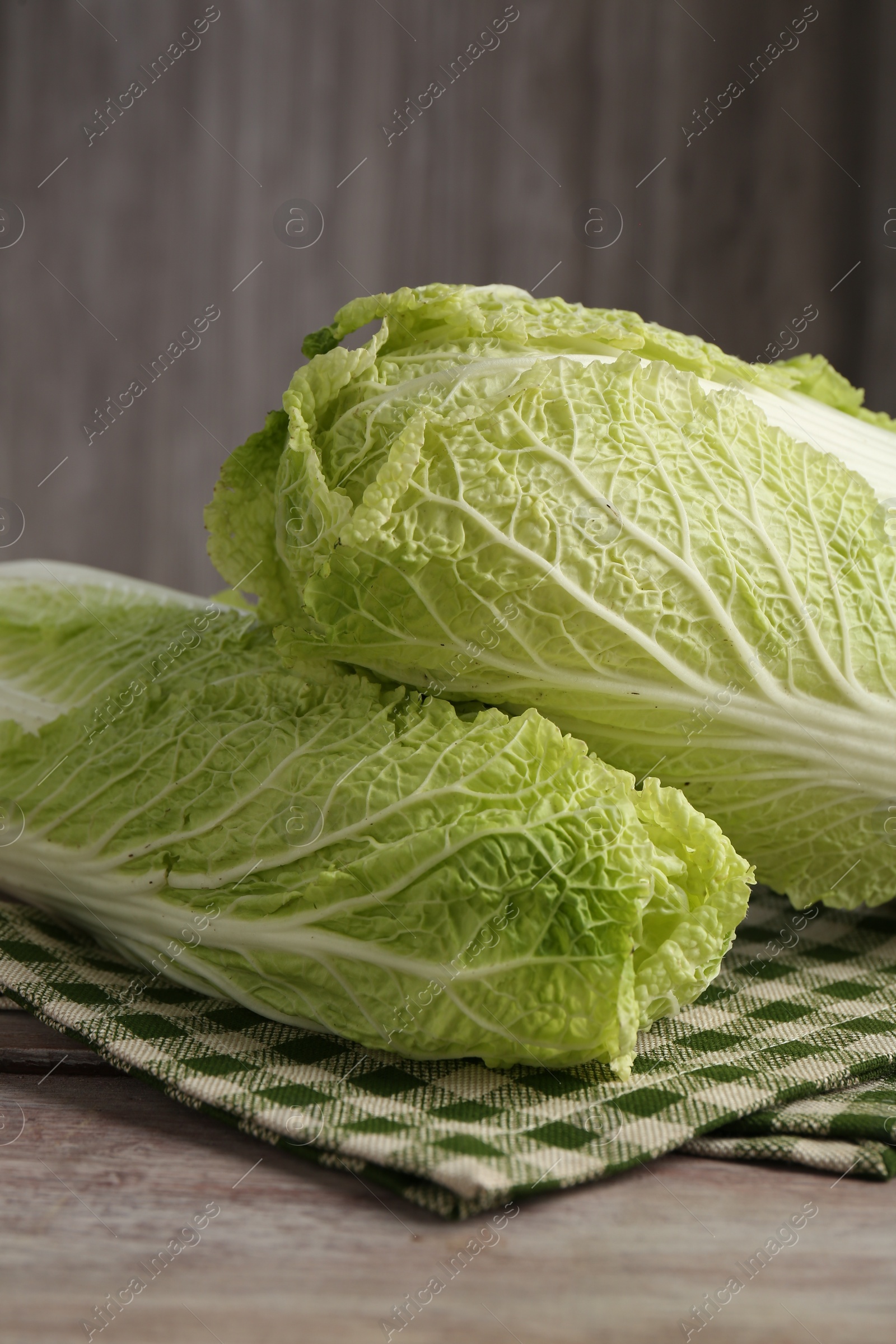 Photo of Fresh ripe Chinese cabbages on wooden table