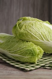 Photo of Fresh ripe Chinese cabbages on wooden table