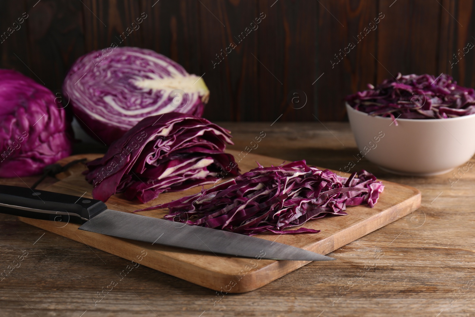 Photo of Fresh chopped red cabbage on wooden table