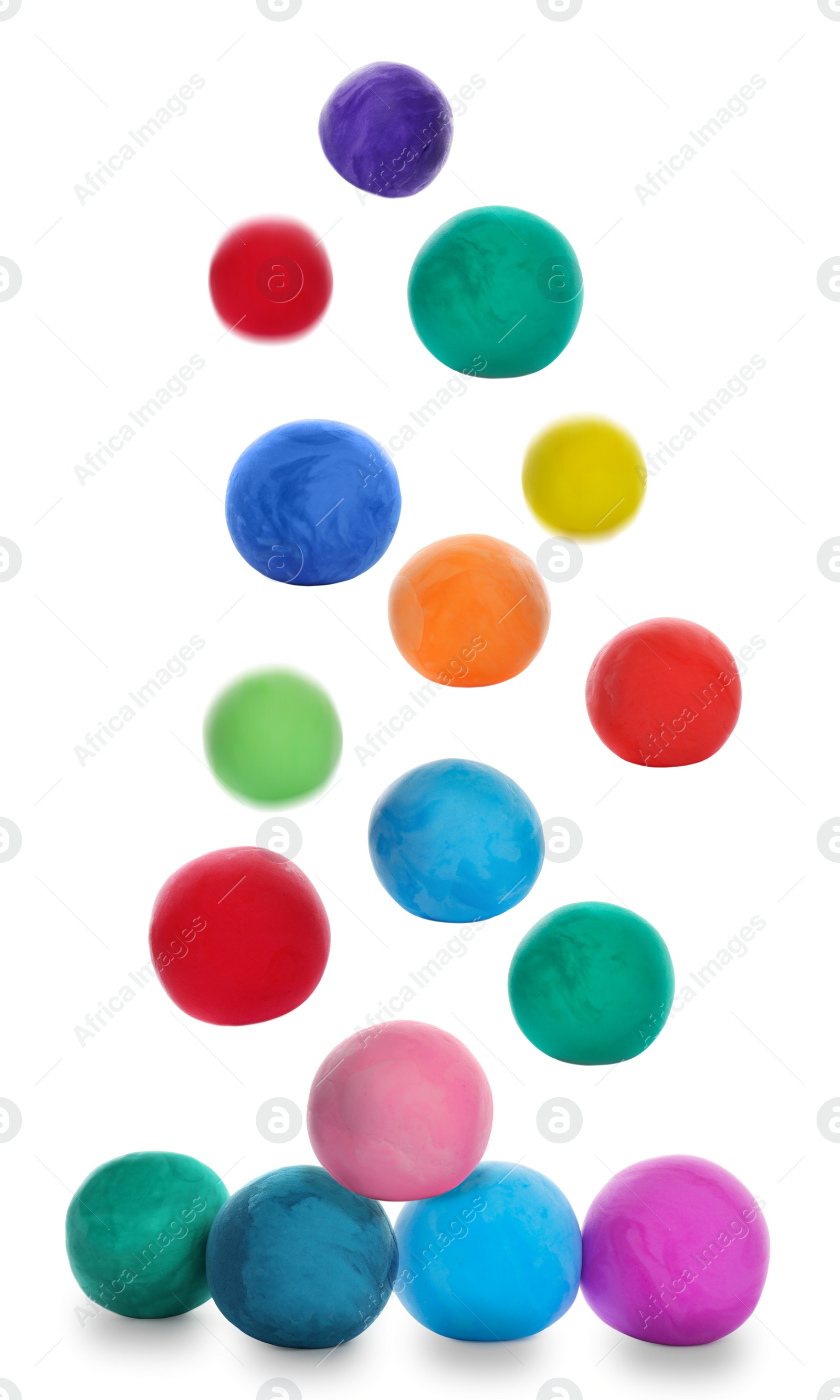 Image of Different colorful play dough falling on white background