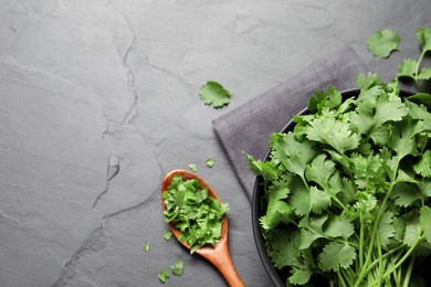 Bunch of fresh aromatic cilantro on grey table, flat lay. Space for text