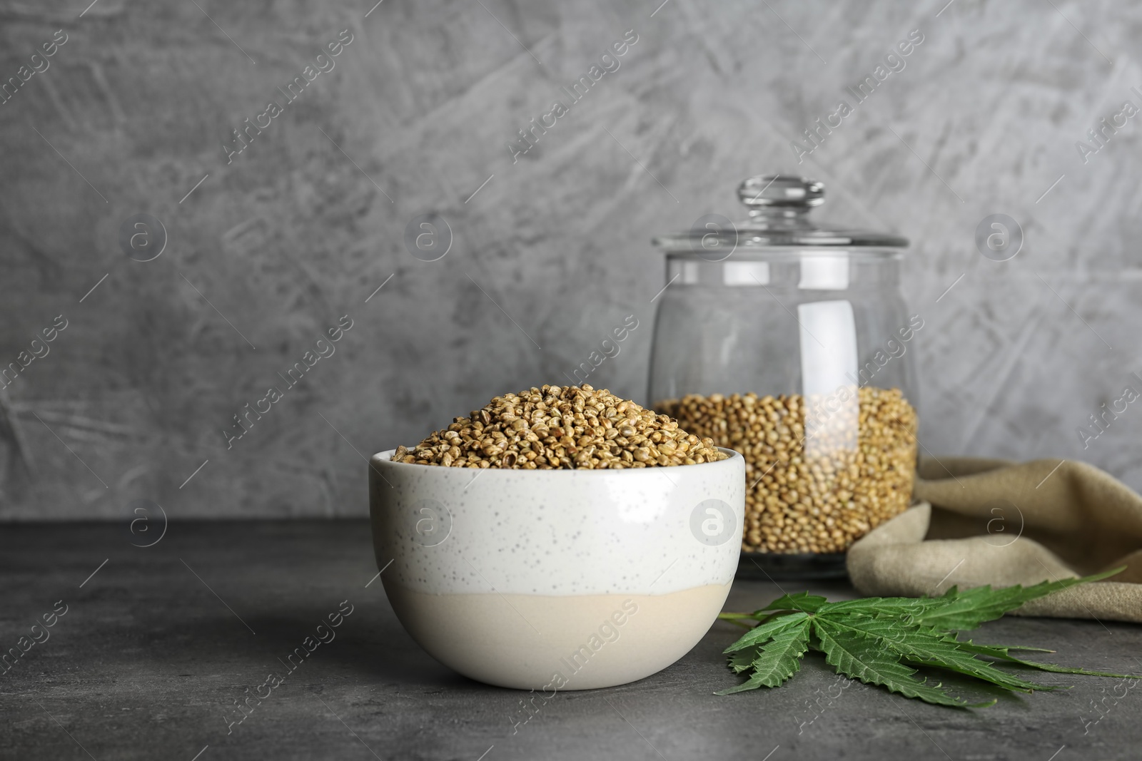 Photo of Bowl of hemp seeds on grey table