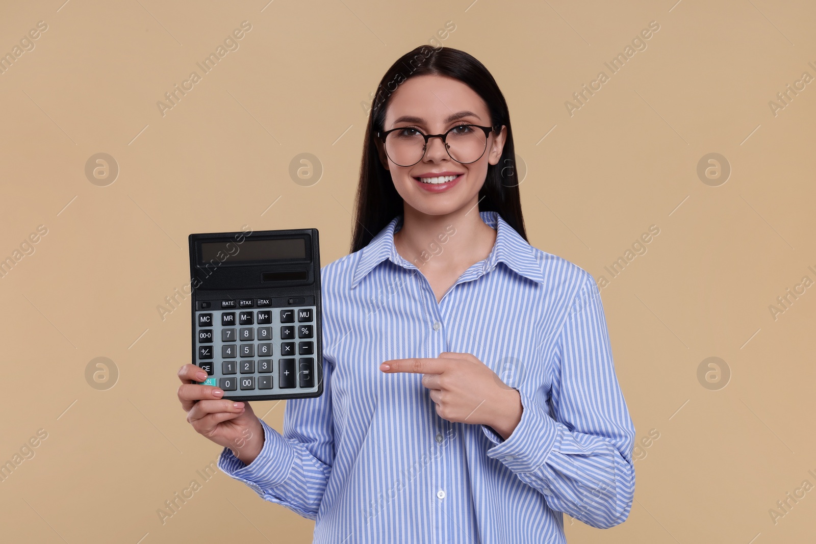 Photo of Smiling accountant with calculator on beige background