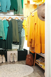 Different stylish clothes and shoes in dressing room. Fashion blogger