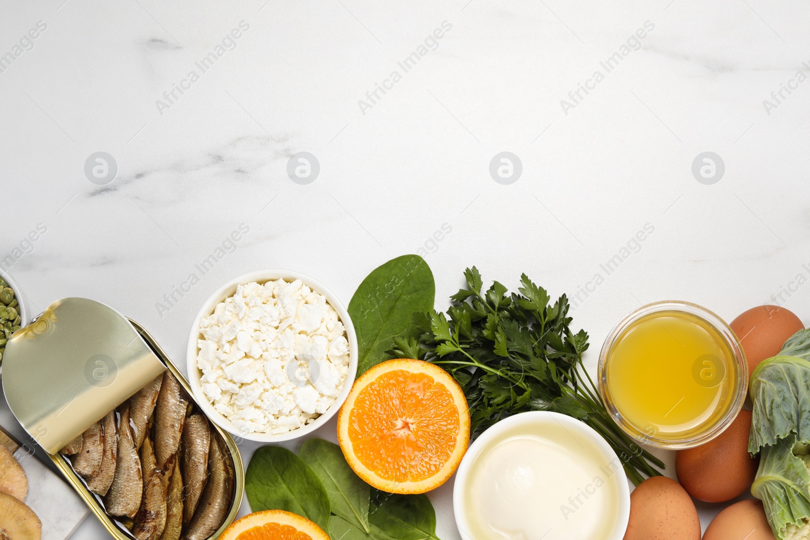 Photo of Set of natural food high in calcium on white marble table, flat lay. Space for text