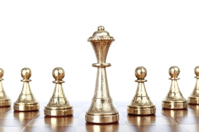 Photo of Queen among pawns on wooden chess board against white background