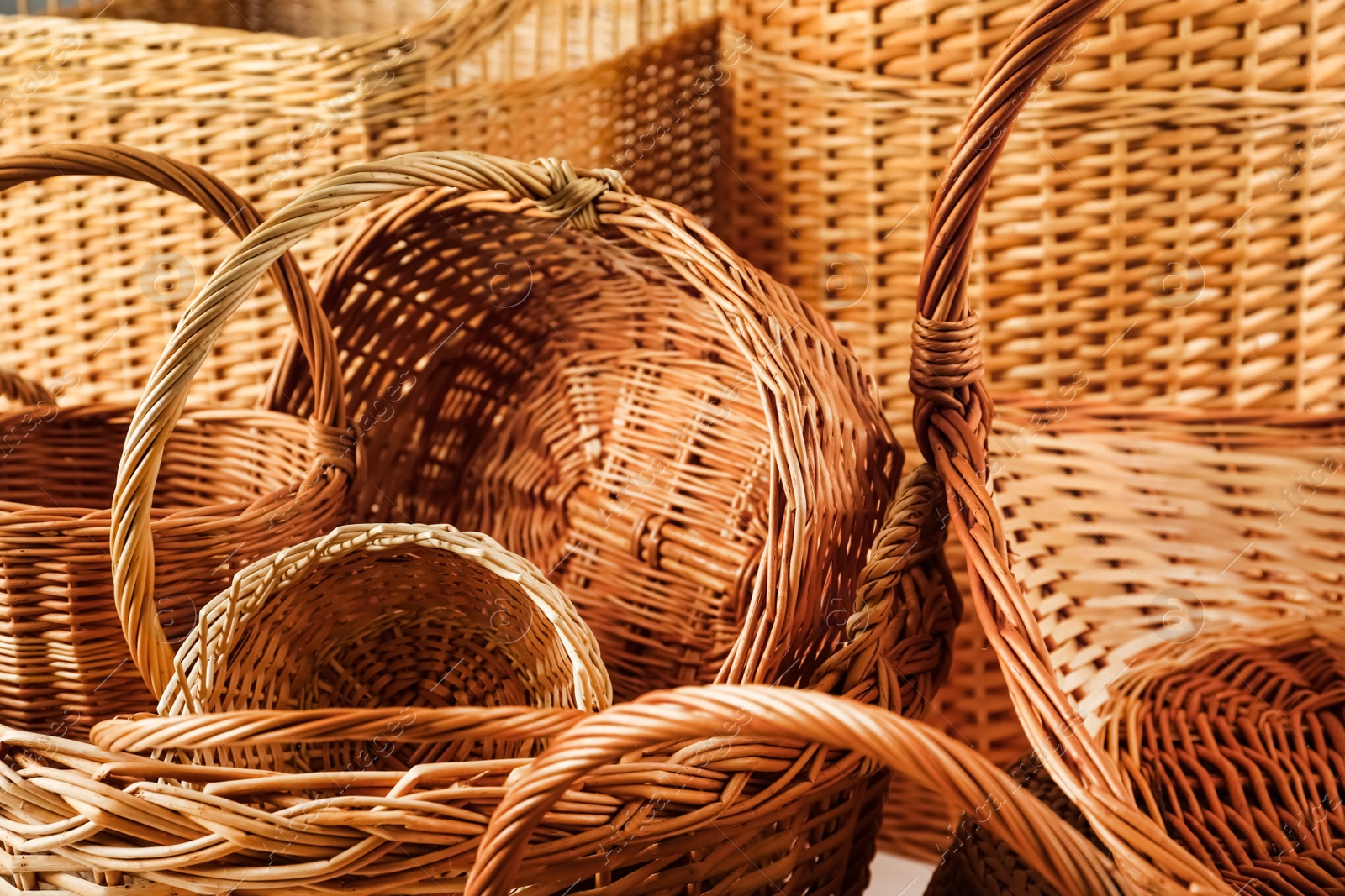 Photo of Many different wicker baskets made of natural material as background