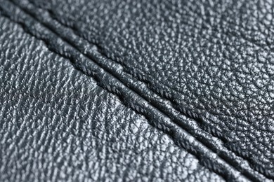 Photo of Black leather with seam as background, closeup