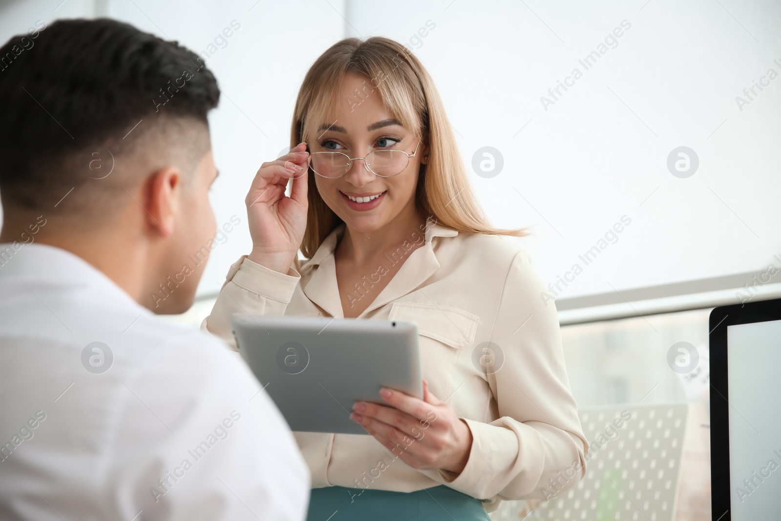 Photo of Colleagues flirting with each other during work in office