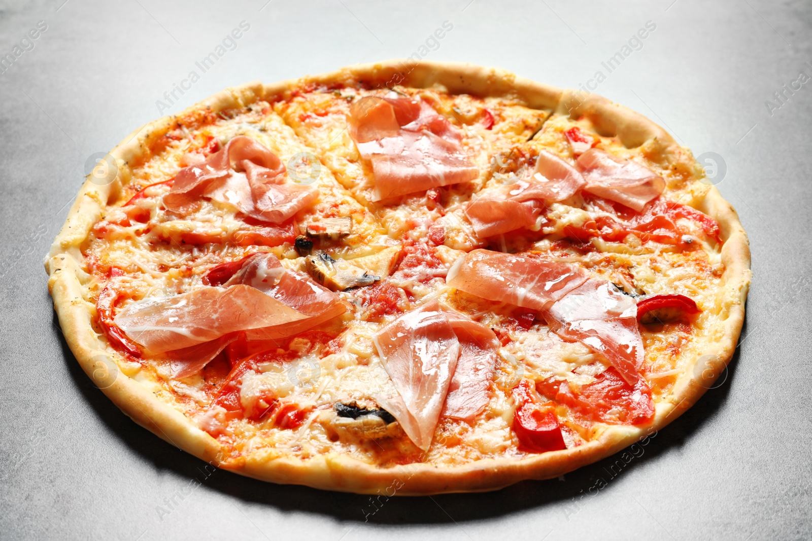 Photo of Delicious pizza with bacon on grey background