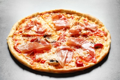 Delicious pizza with bacon on grey background