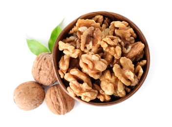 Bowl with walnuts on white background, top view