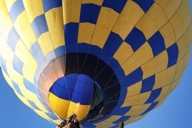 Photo of Beautiful view of hot air balloon in blue sky, closeup