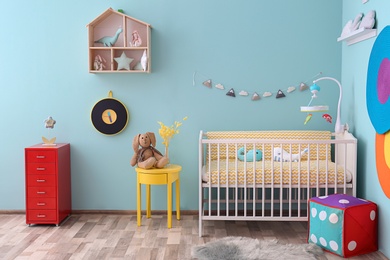 Photo of Interior of baby room with comfortable crib