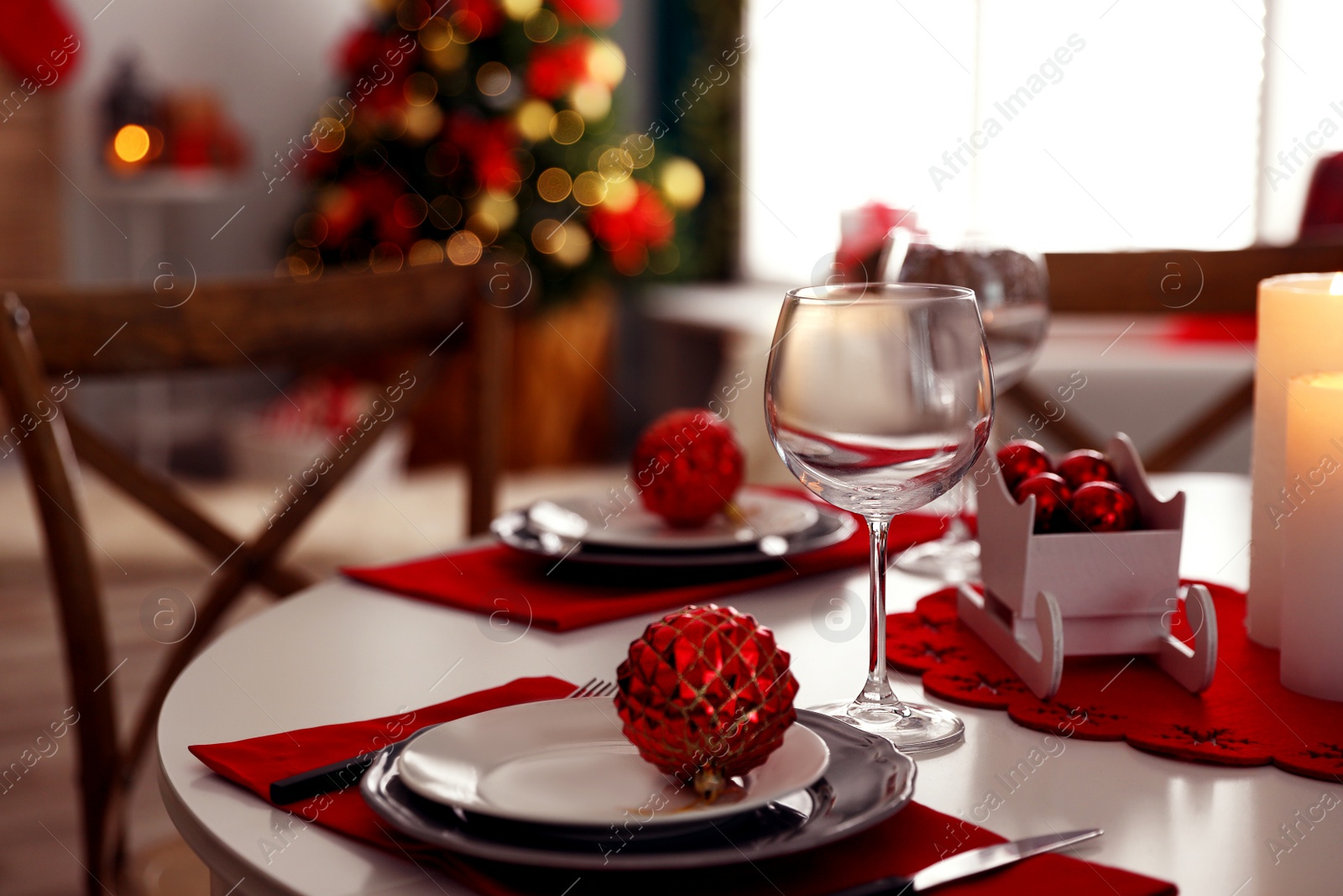 Photo of Festive table setting and Christmas tree in stylish room interior