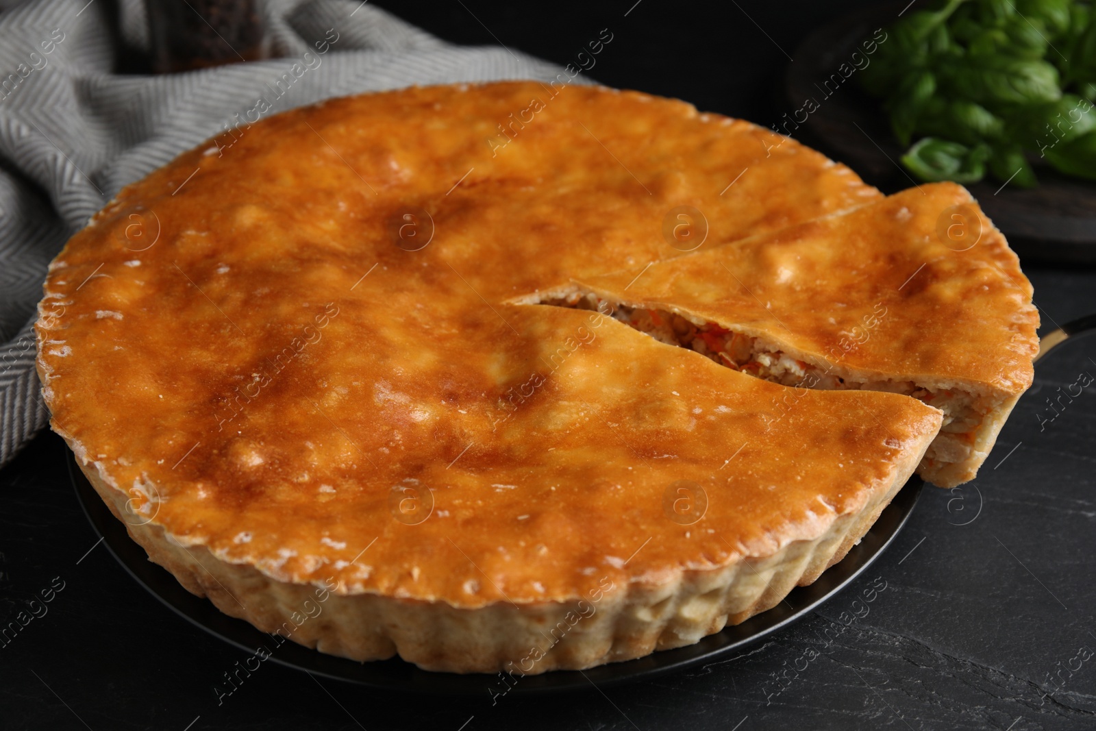 Photo of Delicious pie with meat on black table
