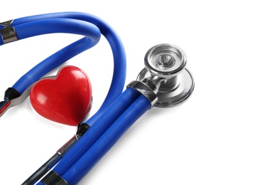 Photo of Stethoscope and small red heart on table. Heart attack concept