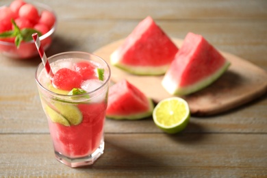 Photo of Glass of refreshing watermelon drink on wooden table