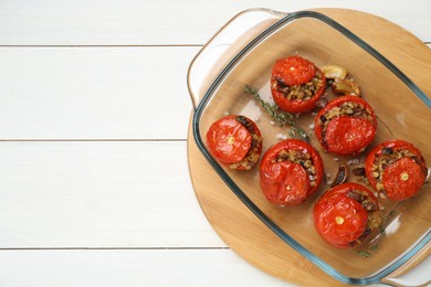 Photo of Delicious stuffed tomatoes with minced beef, bulgur and mushrooms on white wooden table, top view. Space for text