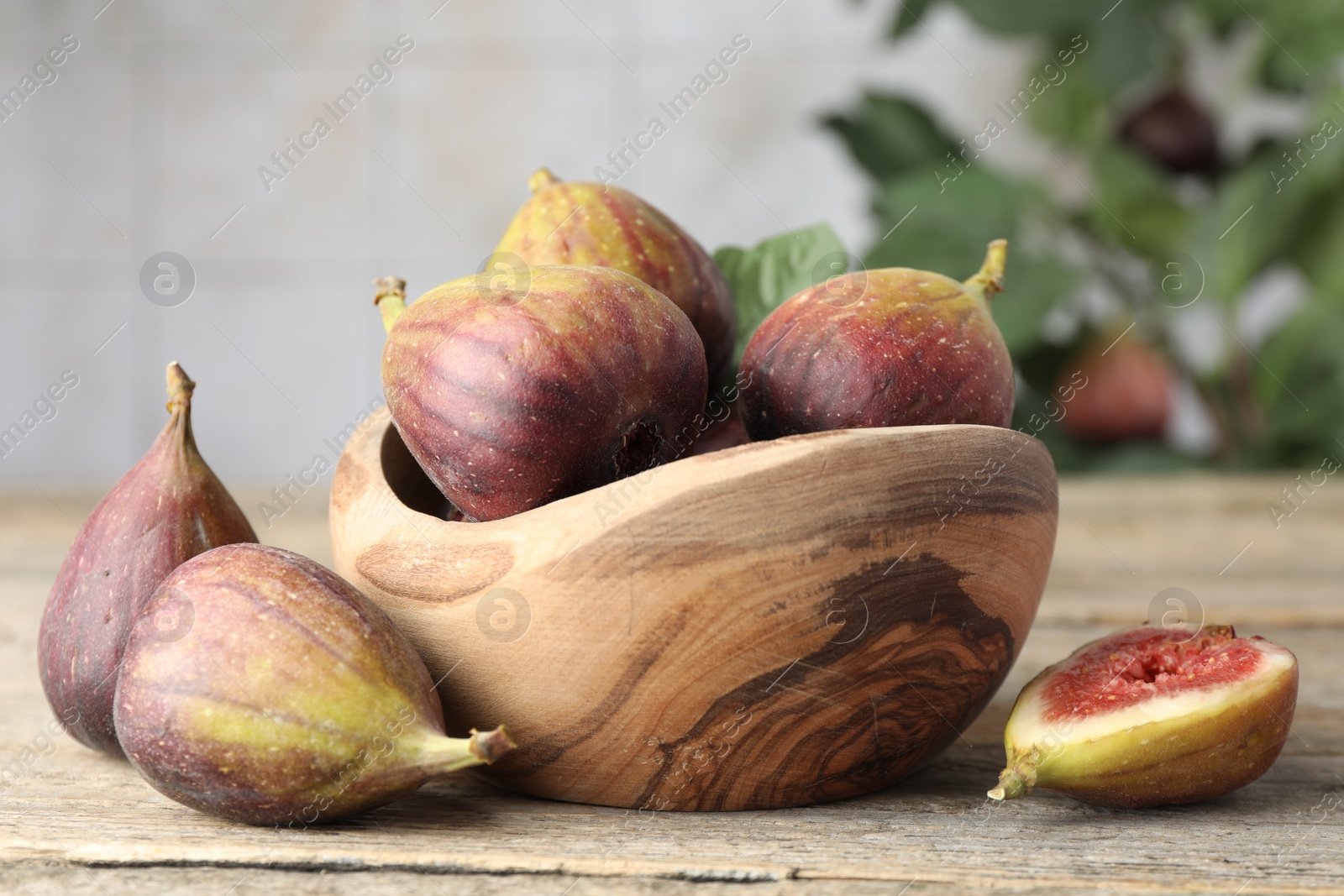 Photo of Many fresh ripe figs on wooden table