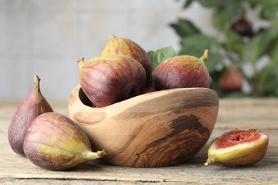 Photo of Many fresh ripe figs on wooden table