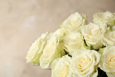 Luxury bouquet of fresh roses on beige background, closeup