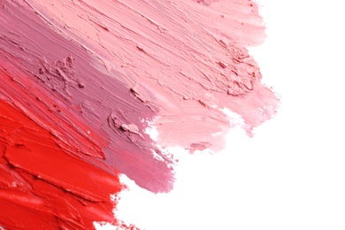 Photo of Strokes of lipstick on white background, top view