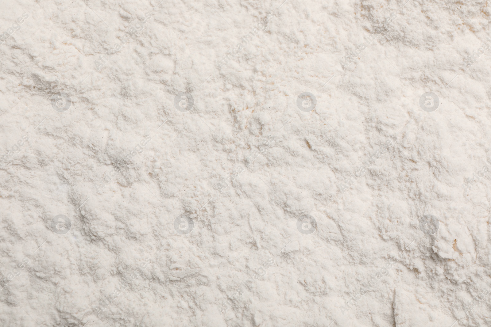 Photo of Pile of organic wheat flour as background, top view