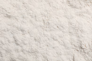 Photo of Pile of organic wheat flour as background, top view