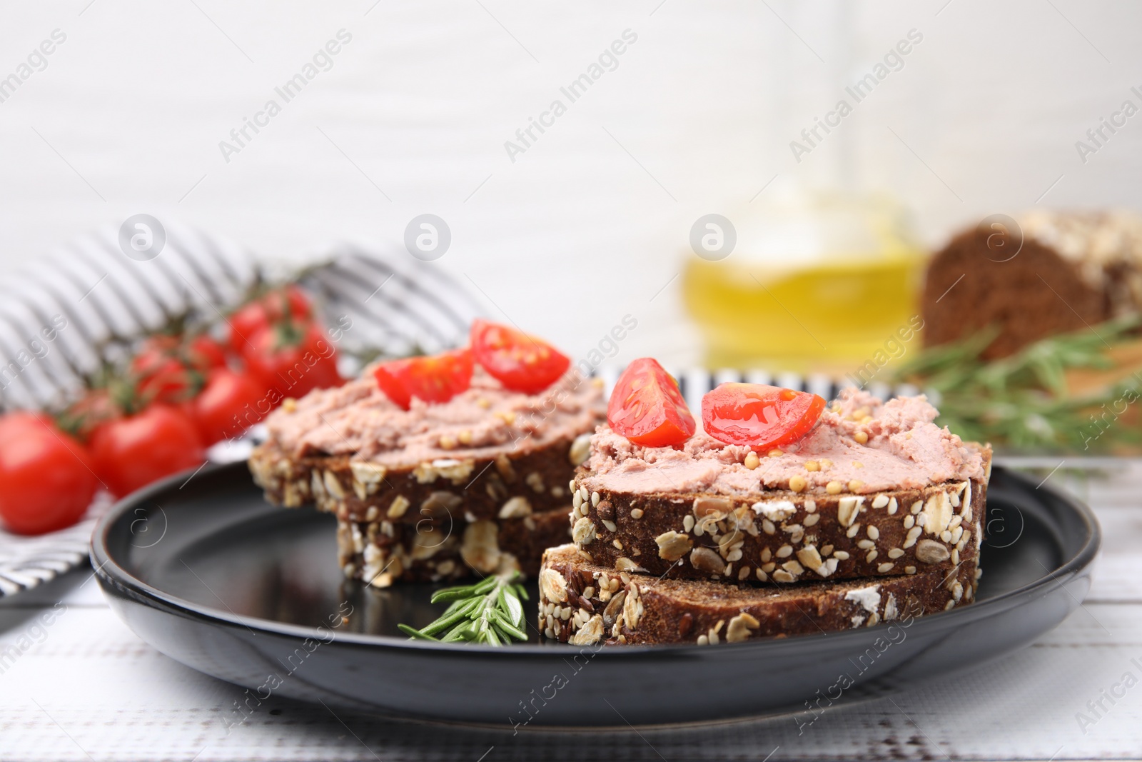 Photo of Delicious liverwurst sandwiches served on white wooden table, closeup