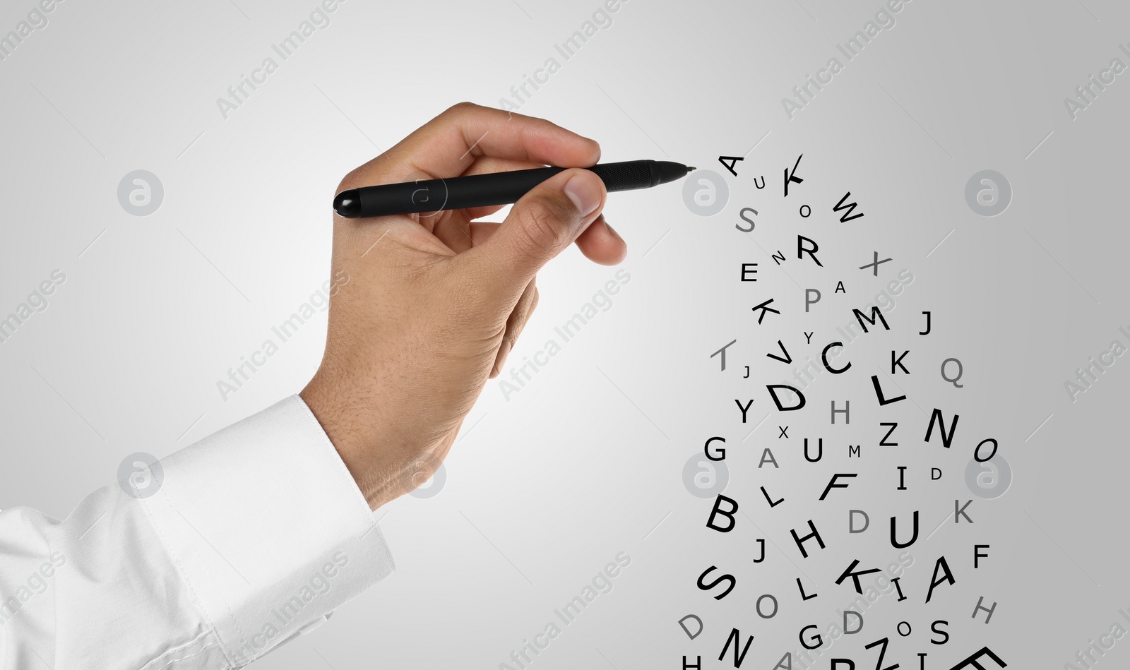 Image of Man writing letters and they flying away on grey gradient background, closeup