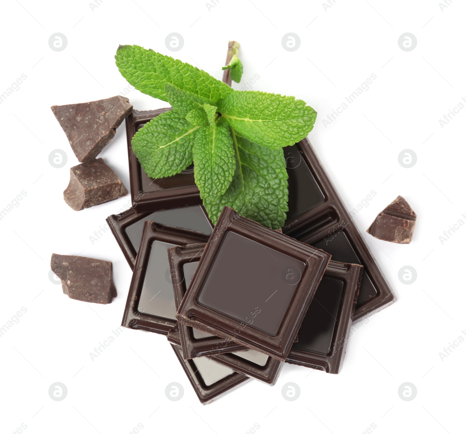 Photo of Tasty dark chocolate pieces with mint on white background, top view