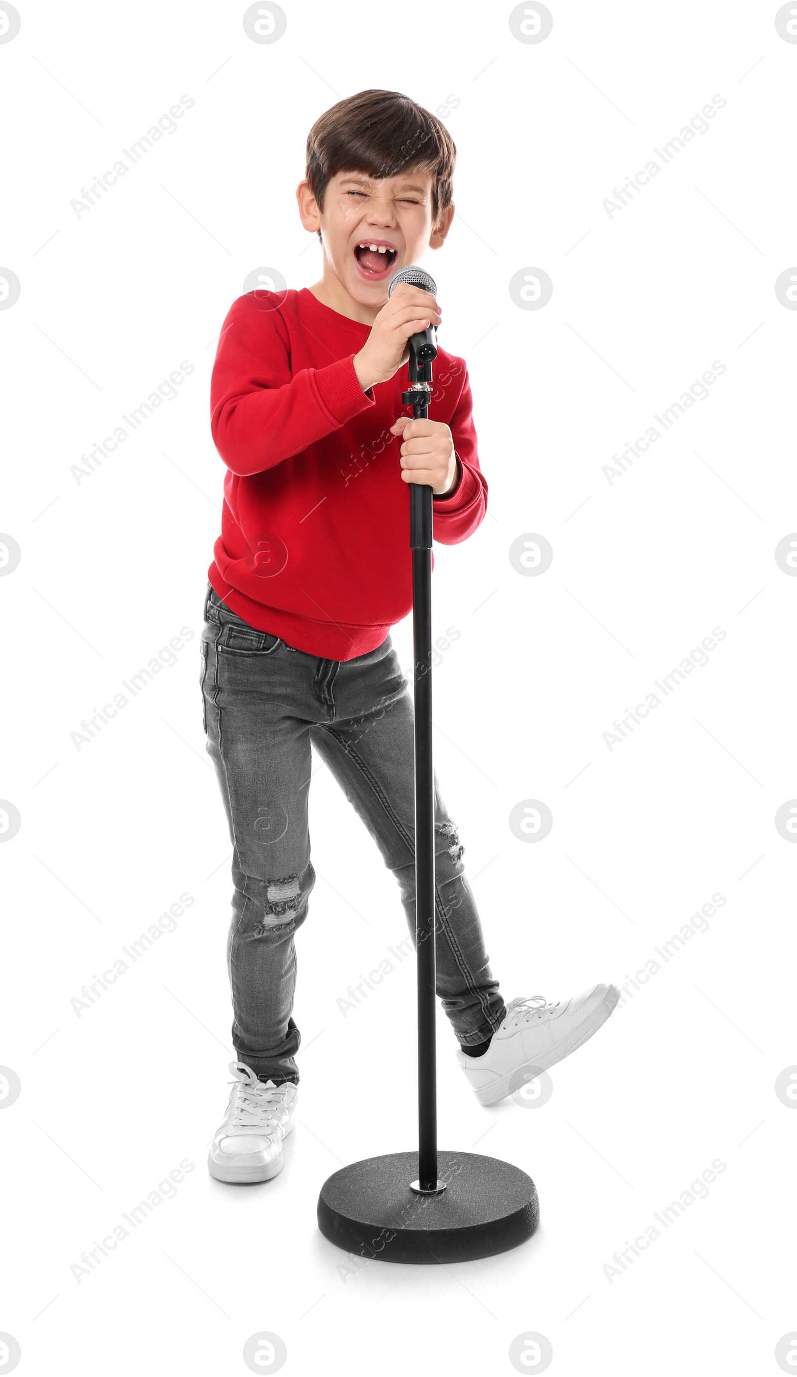 Photo of Cute little boy singing into microphone on white background