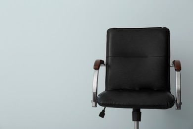 Comfortable office chair on light background. Space for text