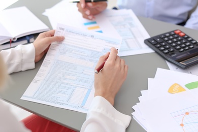 Photo of Tax accountants working with documents at table