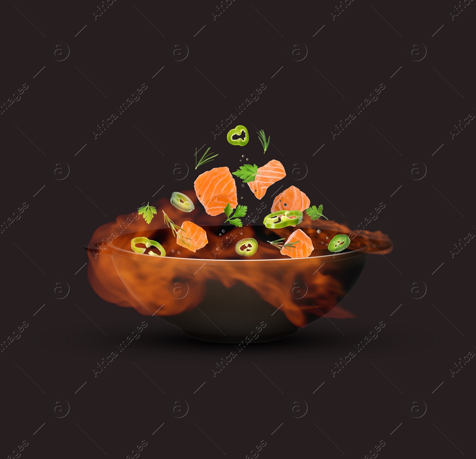 Image of Wok with tasty ingredients and fire on dark background