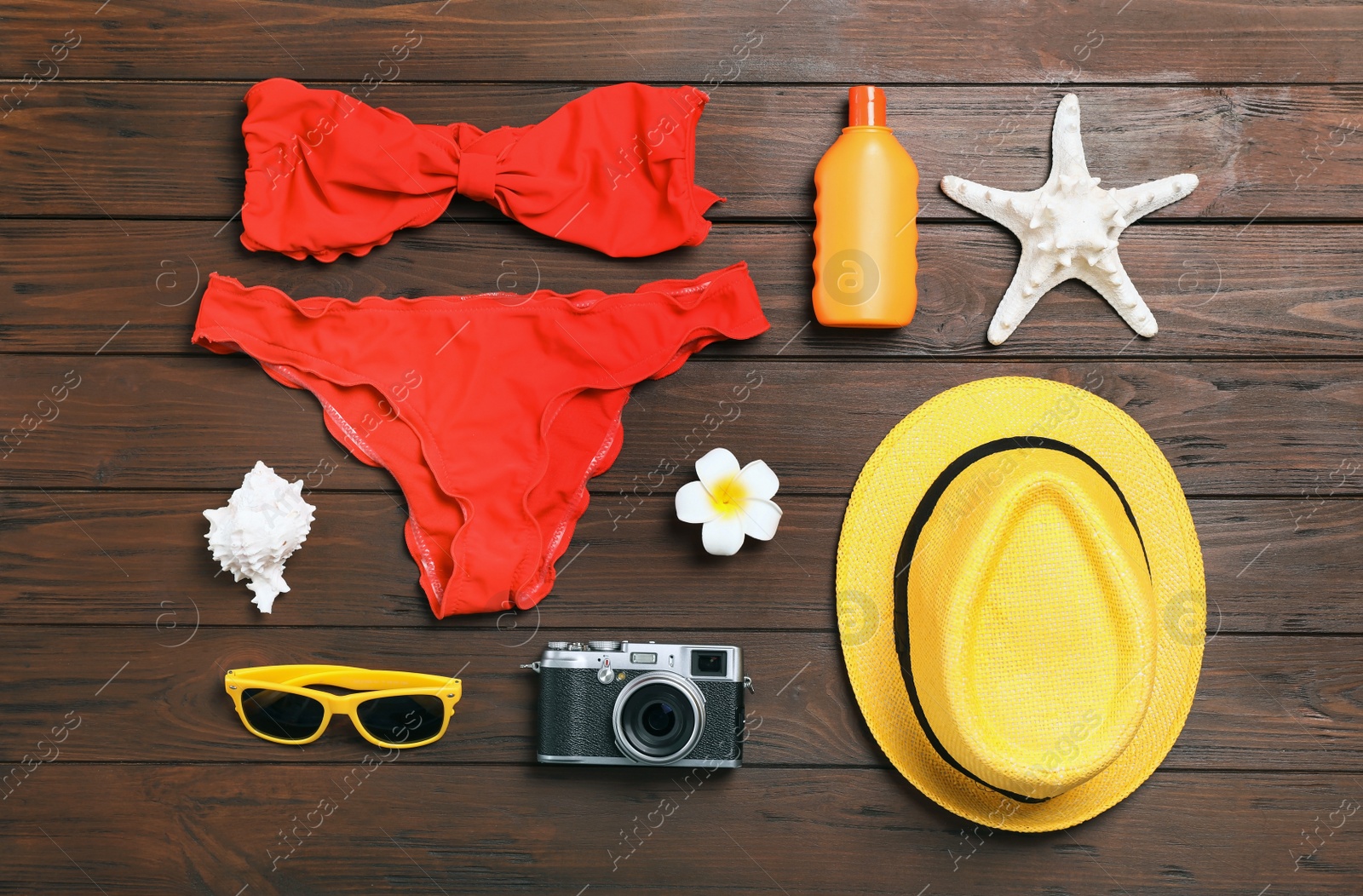 Photo of Flat lay composition with beach objects on wooden background